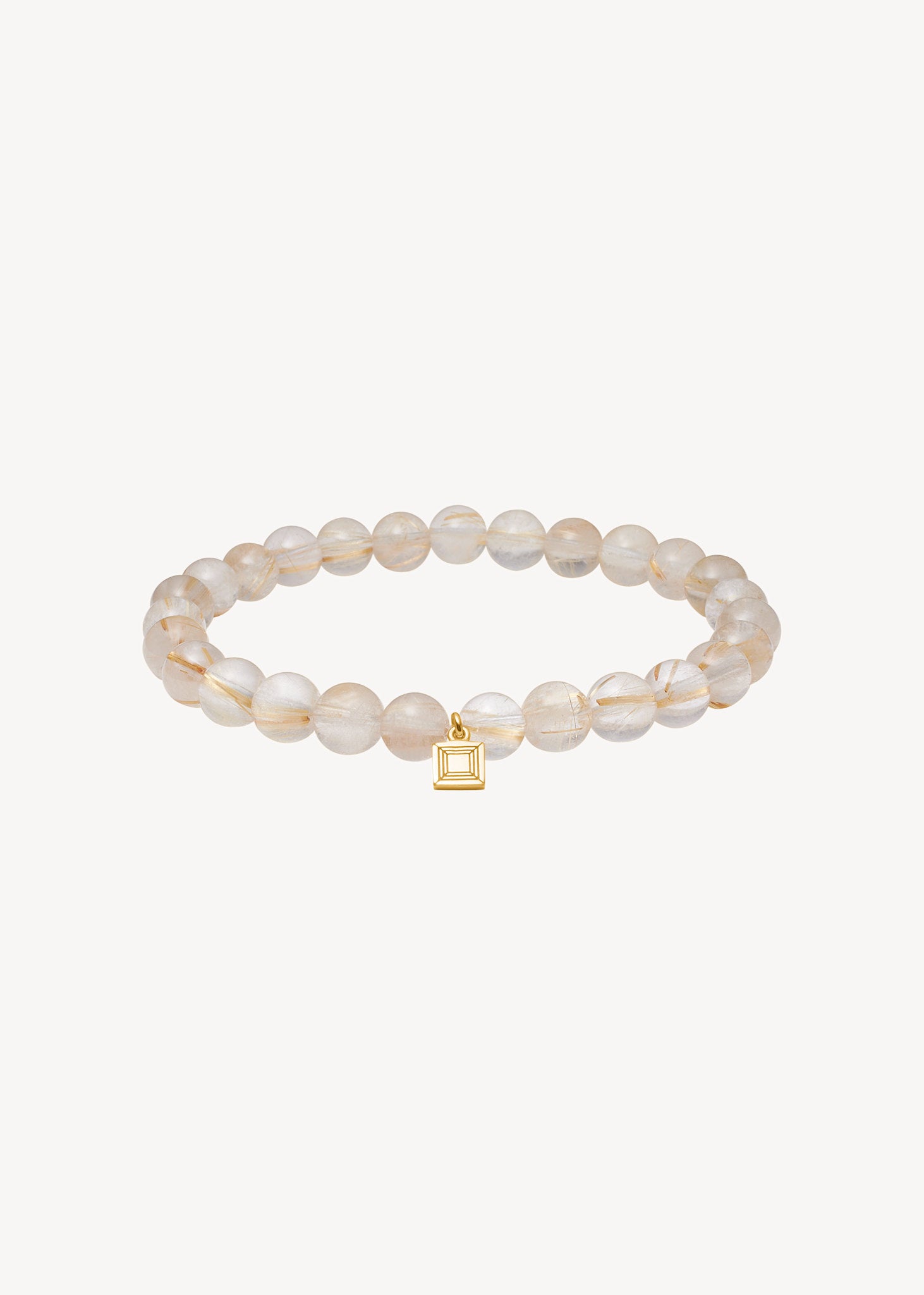 Lido slip on armbånd fra carré jewellery med gyldne rutil kvarts ædelsten, elastik og guldbelagt sølv tag fra carré