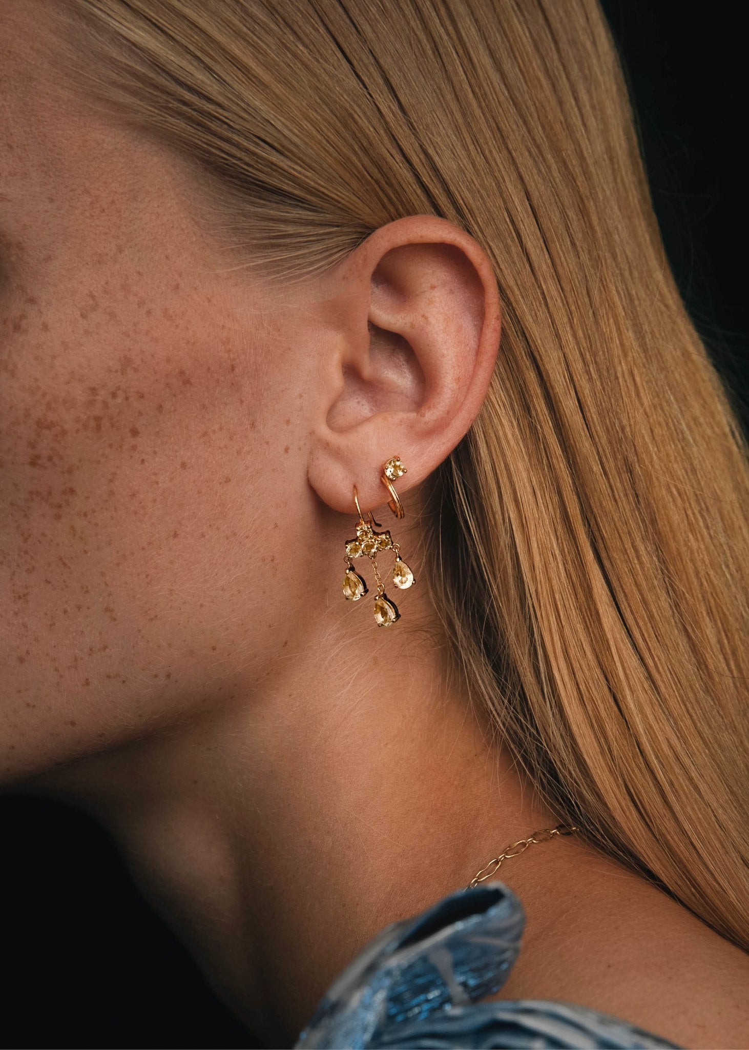 Kvinde med lysekrone øreringe fra carré jewellery med champagne kvarts ædelsten i forgyldt sterling sølv 