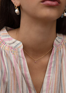Kvinde med lyserødt hjertevedhæng til halskæder i ægte 10 karat guld fra carré jewellery med en hjerteformet pink turmalin ædelsten