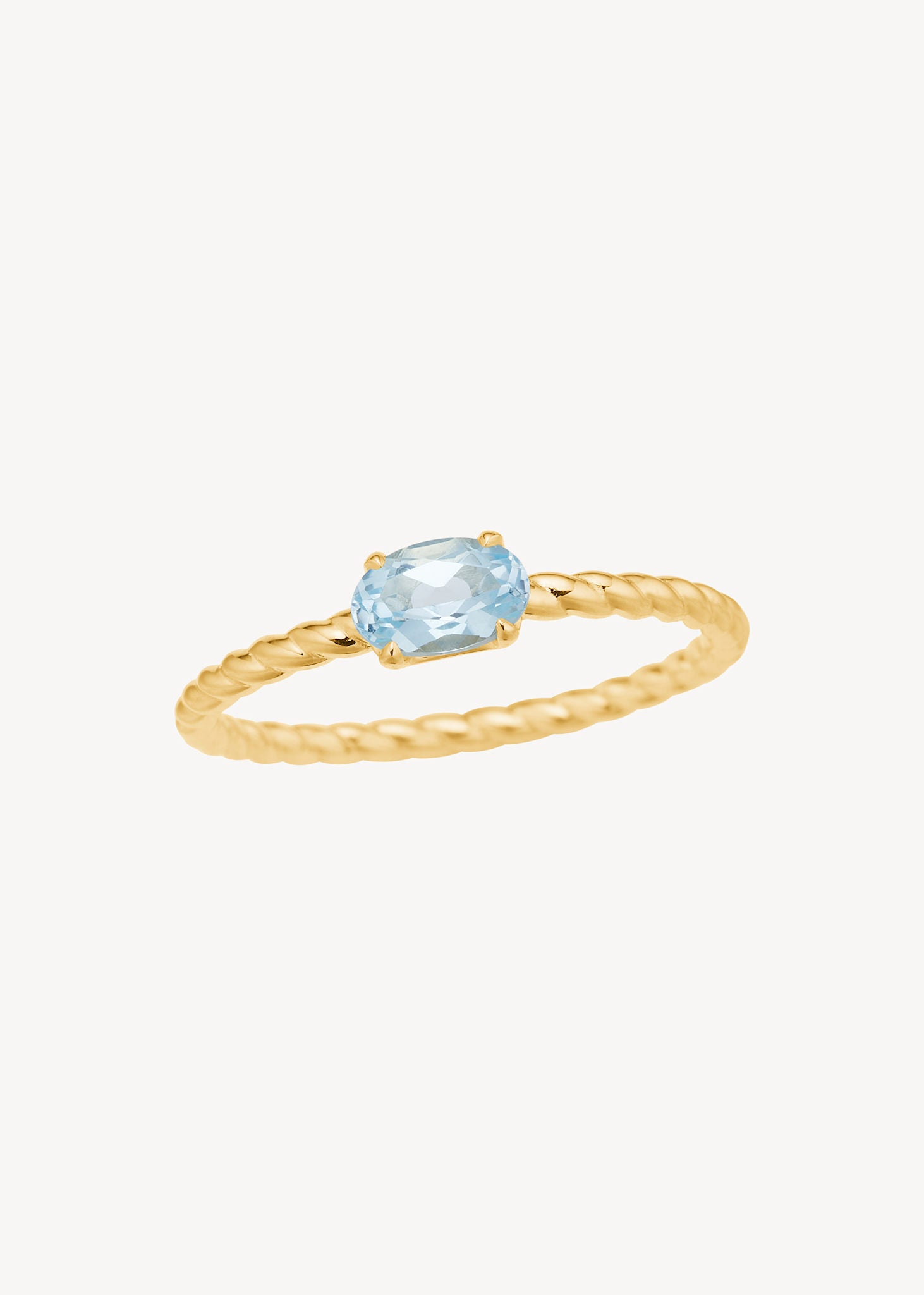 Smuk solitare ring i 10 karat ægte guld med flettet ringskinne sat med novembers fødselssten, blå topas, i en ovalslebning, smuk gave til hende, smykket til bruden med blå sten og gave til hende med fødselssten for november