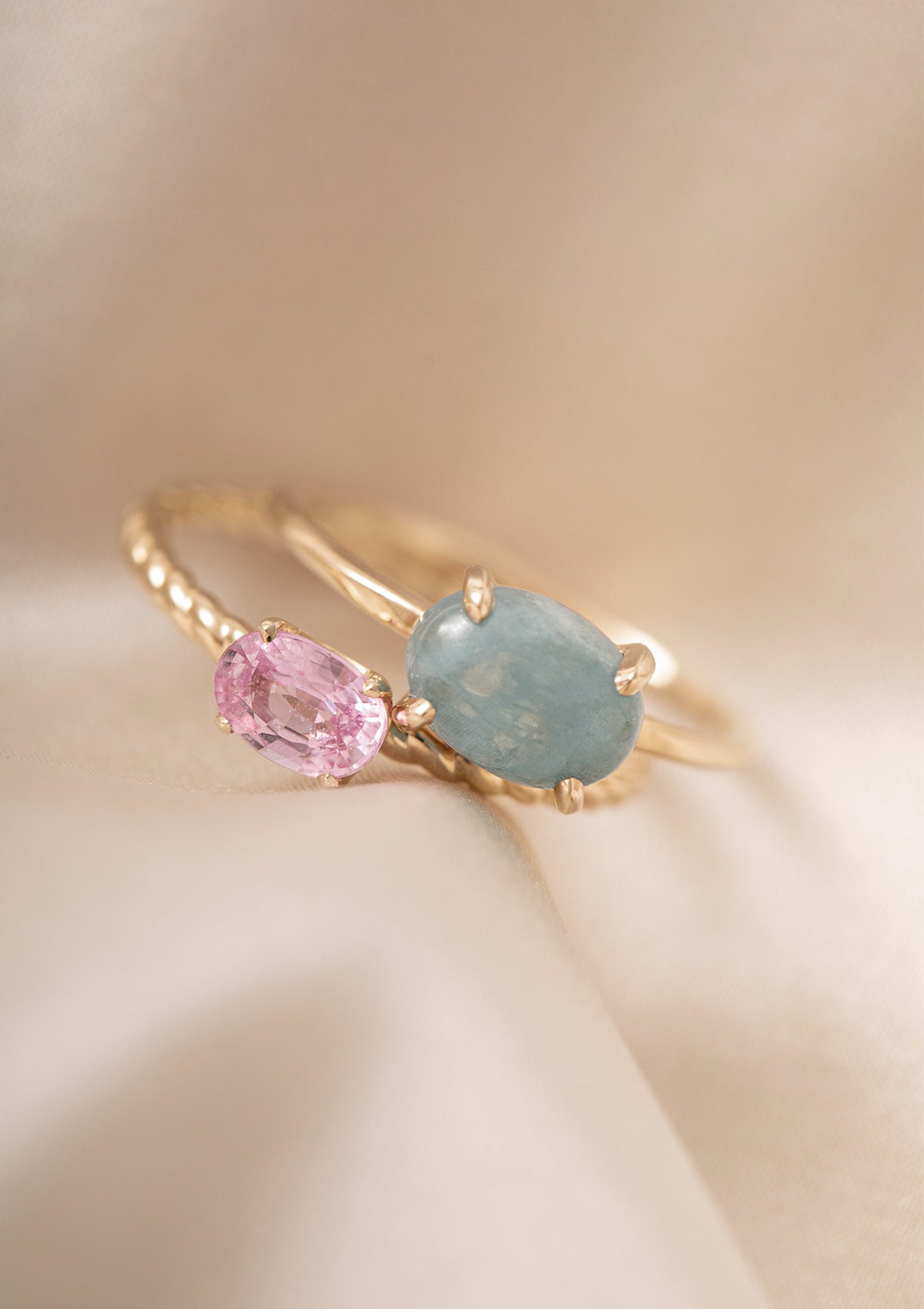 to ringe i 10-karat guld fra Carré. Den ene har en cabochonslebet akvamarin ædelsten og nummer to har en pink safir