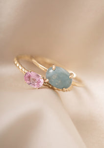 to ringe i 10-karat guld fra Carré. Den ene har en cabochonslebet akvamarin ædelsten og nummer to har en pink safir